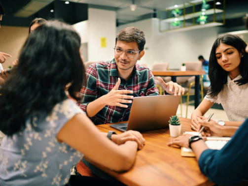 Group of young people discussing new venture  set up in the co-working office